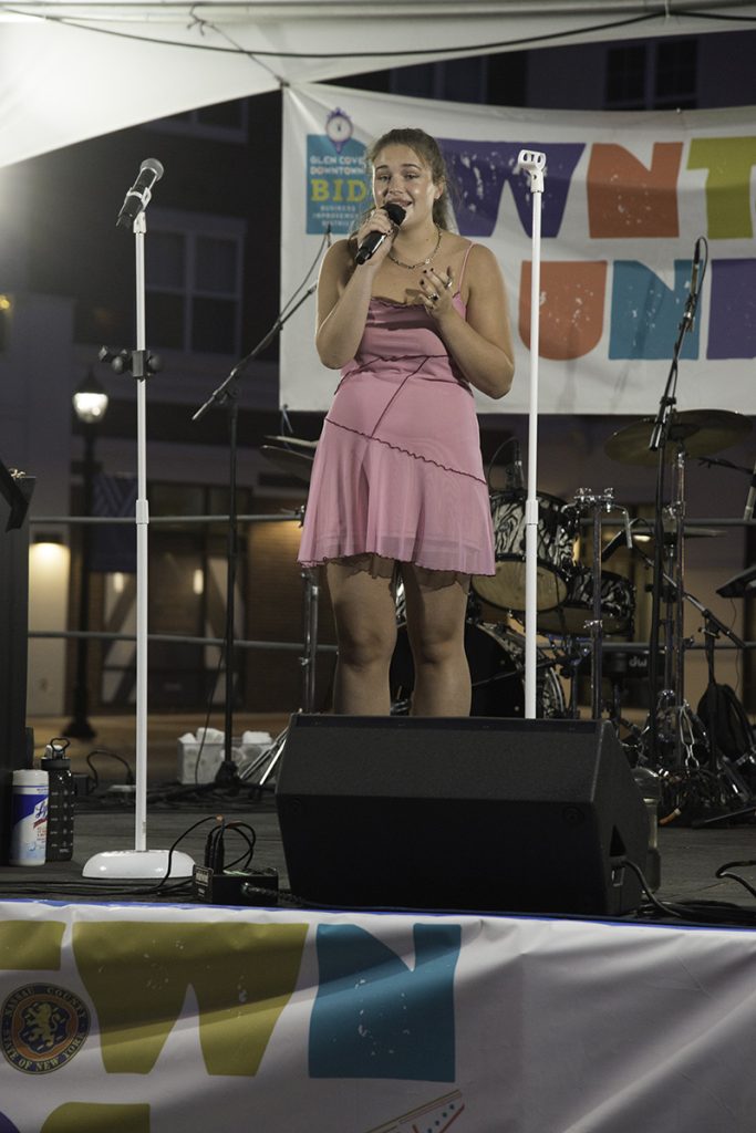 Charlotte Marchioli singing on stage at Glen Cove Downtown Teen Idol performance
