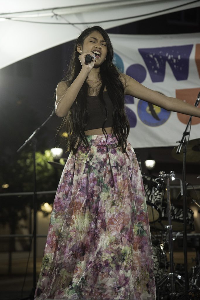 Lexi Briones singing on stage at Glen Cove Downtown Teen Idol performance