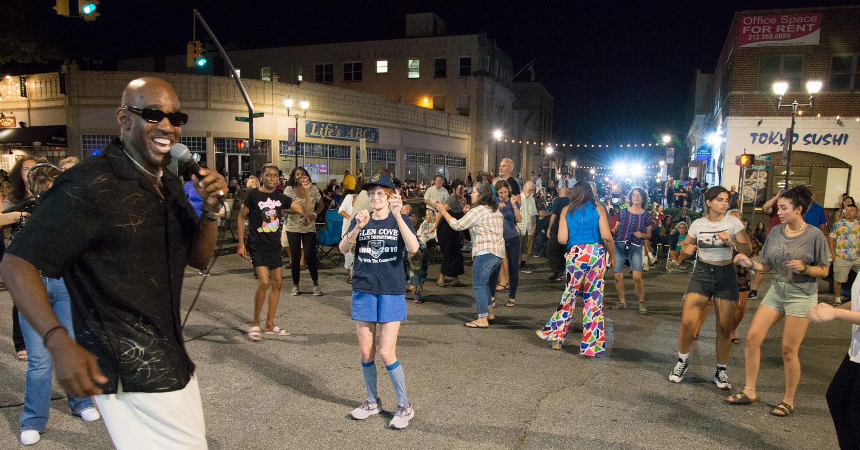 Forever Ray steps off stage to sing and dance with Downtown Sounds attendees