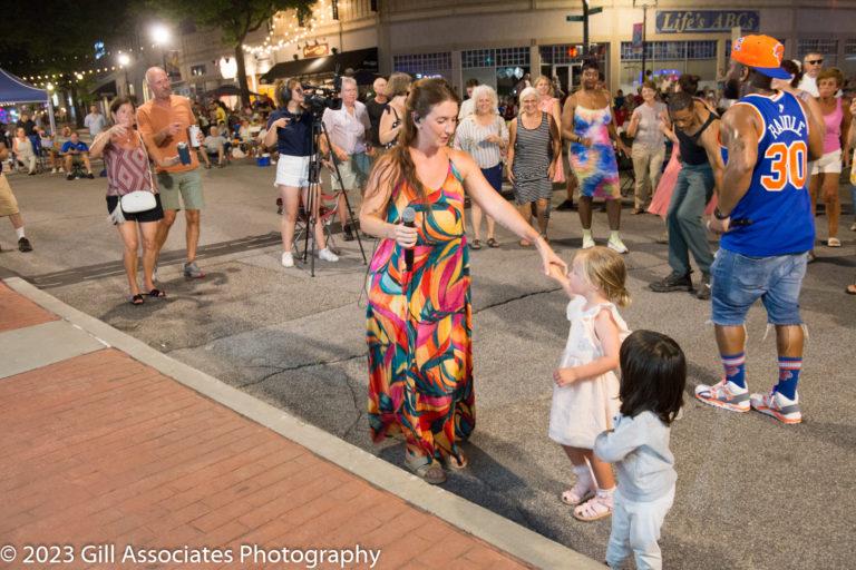 Paradigm member dancing with kids