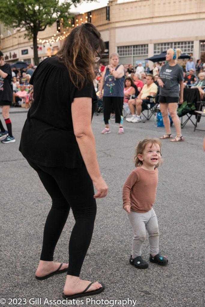 Woman and child dancing to Arena Rock downtown