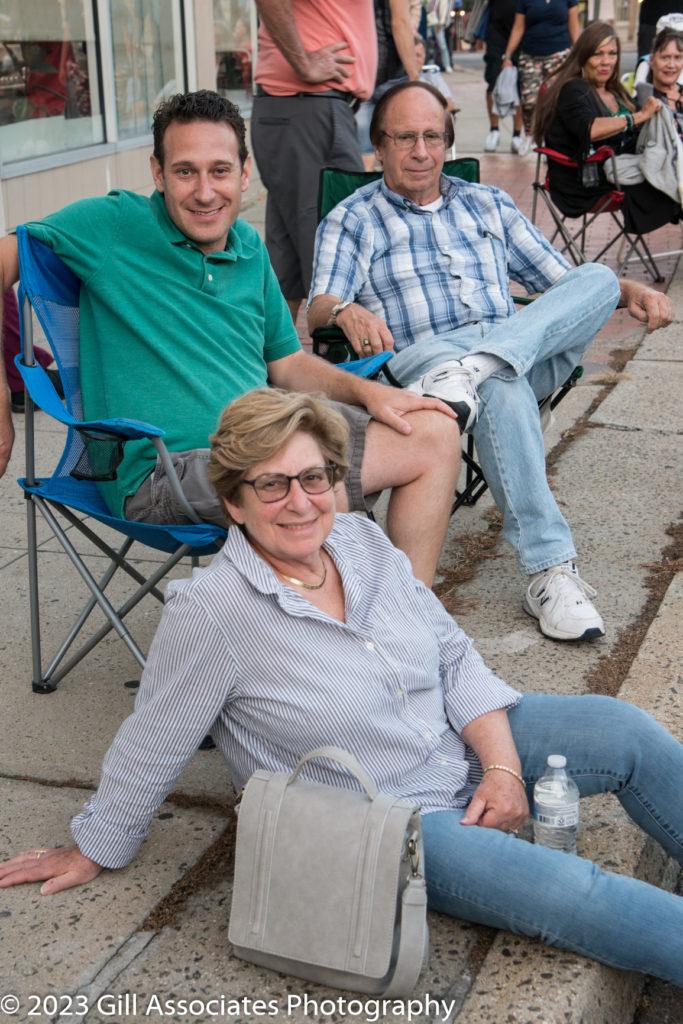 People hanging out and listening to Arena Rock downtown