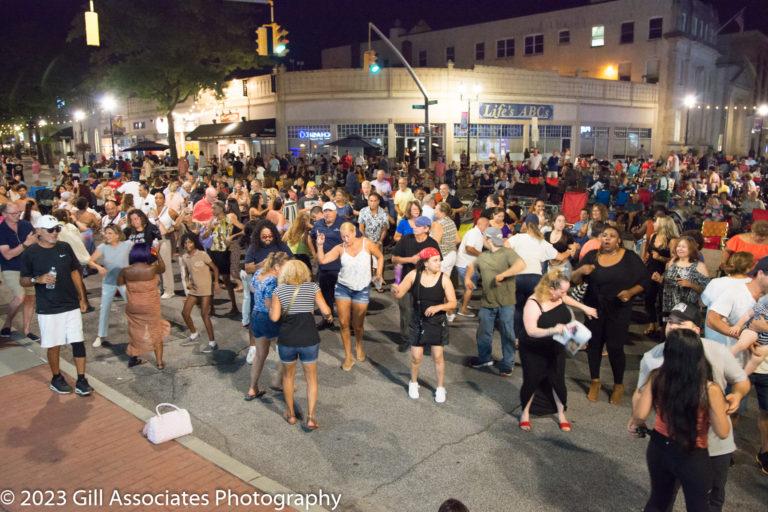People take to the streets of downtown to salsa.