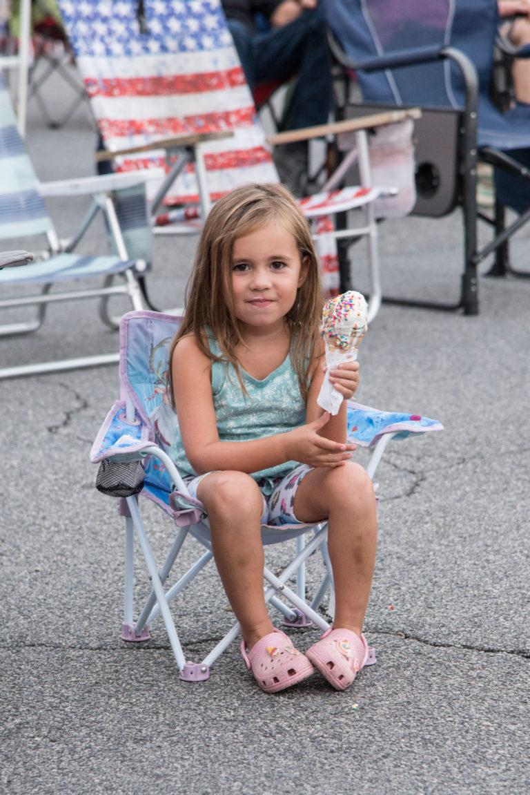 A young child enjoys ice cream at Downtown Sounds